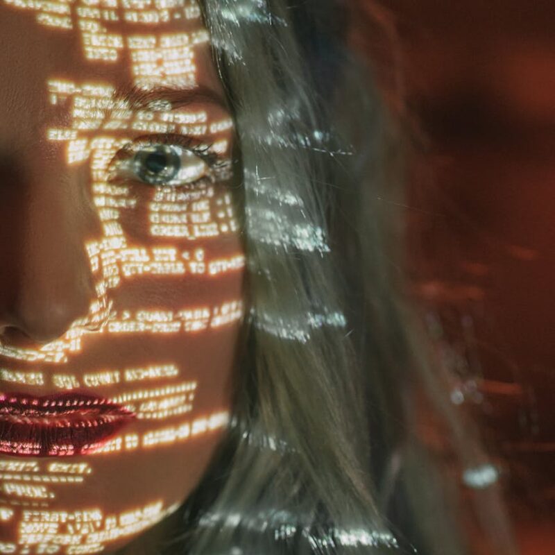 woman with text projected on her face