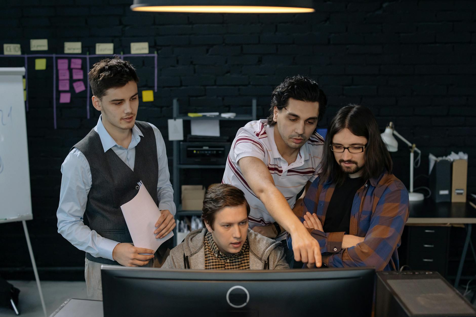 team discussing project at a computer